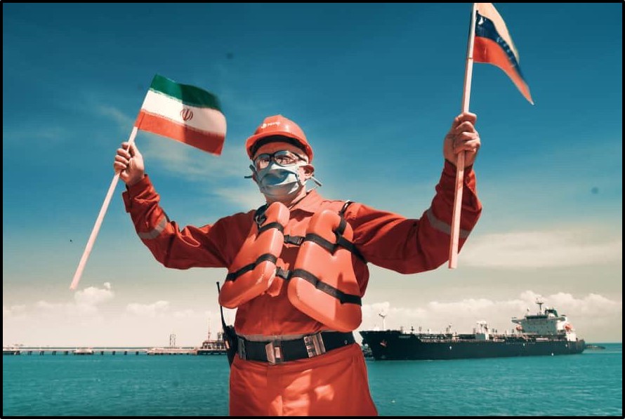 A sailor waves the Iranian and Venezuelan flags
