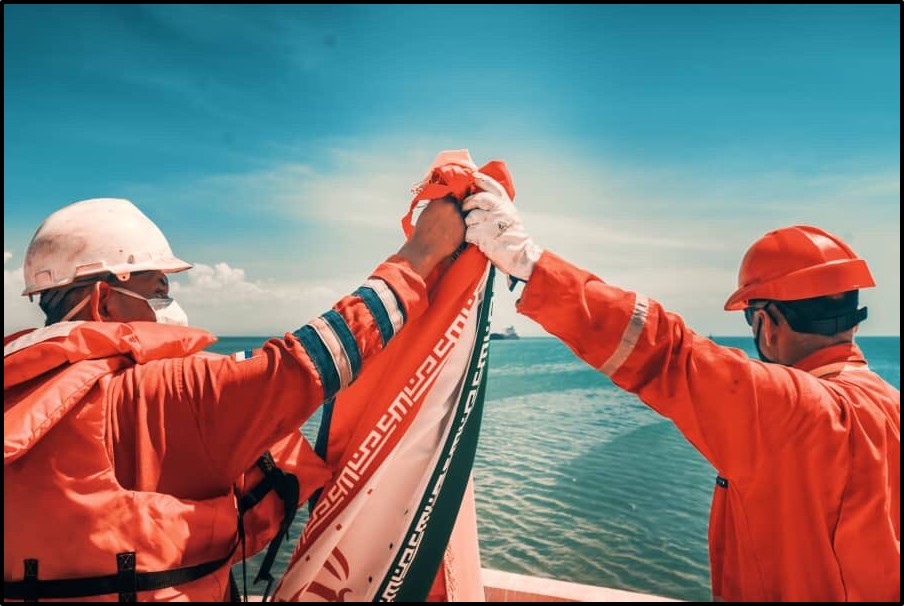 Iranian and Venezuelan workers clasped hands