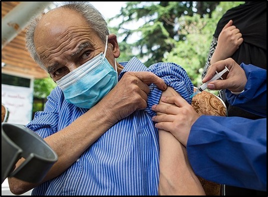 An elderly man at a vaccination center for those over 75