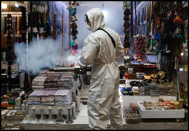 A worker cleans a store at Tajrish Bazaar in Tehran