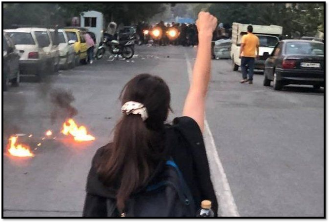 A young woman facing riot police in Rasht